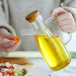 Fancy glass oil dispenser with bamboo lid.
