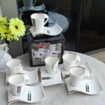 White 12pc cup and saucer set with gold rim